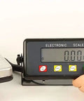 Heavy Duty Digital Postal Scale With Crisp Lcd Display and hidden storage compartment, showing LCD screen and buttons, ideal for parcel weighing.