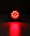 Red glowing Trucker Grade 2 Inch Round LED Marker Light with reflectors for truck RV and trailer side clearance lights.
