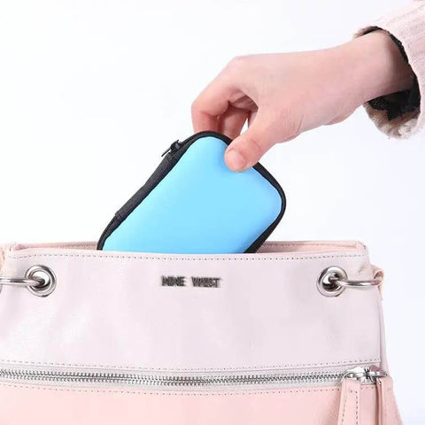 Compact Purple Charger Organizer Storage Case Durable Hard Shell being placed in a pink handbag for easy tech storage.