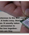 Person connecting Dual Band WiFi Antenna 2.4GHz And 5GHz High Gain 10dBi RP SMA Male Cable to WiFi card.