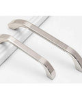 Brushed Nickel Cabinet Handles Three Pack With 64 Millimeter Hole Centers Euro Style Drawer Pulls shown on white surface