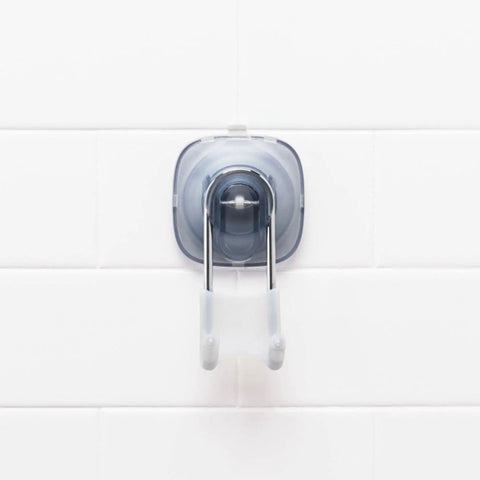Clear suction shower hook with silicone grip on white tile for loofahs, towels, razors. No drill strong suction cups for smooth glass.