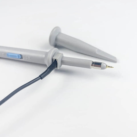 Close-up of 100MHz Oscilloscope Probe Kit with BNC clip probes and attenuation adjustable 1x or 10x grounding alligator clip.