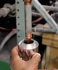 Liquid-O-Ring HT-1800 copper anti-seize lubricant, 8oz brush-top can; copper threaded rod being lubricated in workshop.