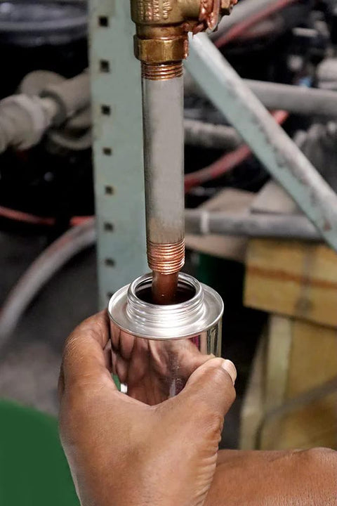 Liquid-O-Ring HT-1800 copper anti-seize lubricant, 8oz brush-top can; copper threaded rod being lubricated in workshop.