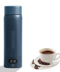 On The Go Travel Electric Kettle Compact Mini Water Boiler 316 Stainless Steel Interior 16.9 Oz Capacity Four Temperature Settings Fast Boil Auto Shut Off Boil Dry Protection Blue Spruce Finish shown next to a cup of coffee.