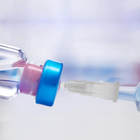 Prime Condition 100 Pack 27 Gauge Half Inch Syringe Needles with Reliable Luer Lock Tips connecting to a vial.