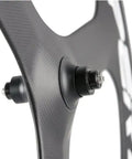 Close-up of Tri Spoke Carbon Wheelset for 700c Road Bikes with Matte Finish Clinchers showcasing hub attachment.