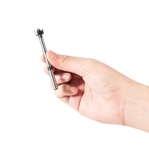 Hand holding a Straight Shooting Precision Forstner Bit from the 16 Piece Pro Drill Kit for woodworking and carpentry.