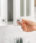 Person using Solid Zinc Alloy 10 Pack Brushed Nickel Kitchen Cabinet Knobs on white cabinet doors, showcasing farmhouse style.