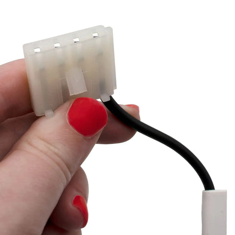 Hand holding connector of Model Specific Refrigerator Ice Maker Assembly Replacement 120V 8 Cube With Harness And Bail Arm Extension