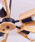 Modern Metal Pendant Chandelier With Five E27 Sockets And Compatible Slim Led Fixtures Sleek Black Finish top view showing wooden accents.