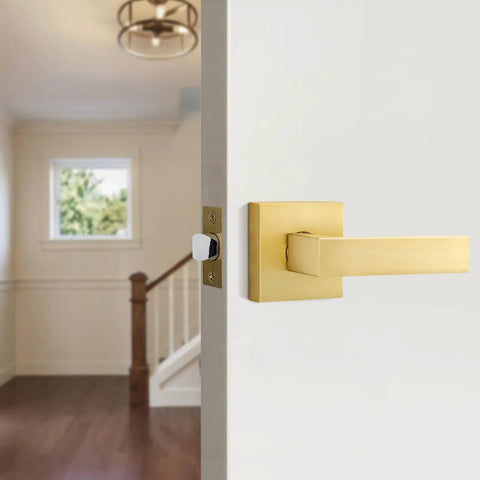 Close-up of a single-sided gold dummy door handle on an interior door, showcasing heavy duty satin brass finish for decor.