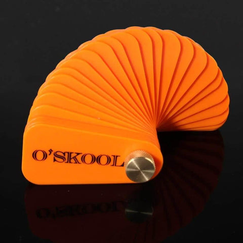 Orange O'Skool bench vise stop spacer set with shims, viewed from the side, designed to prevent racking and ensure even clamp force.
