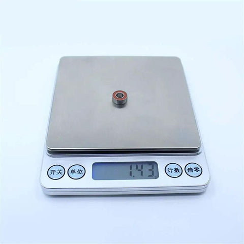 MR115RS 5x11x4 Mm ABEC-3 2RS Orange Sealed Ball Bearing on digital scale for RC cars and trucks