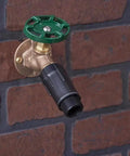 Three Quarter Inch Hose Pressure Regulator For Drip Irrigation, No More Emitter Pop Offs, Reduces Water Pressure To 25 To 30 PSI, Black, Easy Install, Durable Inlet attached to outdoor spigot on brick wall.