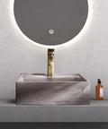 UMJIGF Vessel Sink Small Apartment Above Counter Basin Concrete Wash Basin on a modern countertop with a golden faucet.