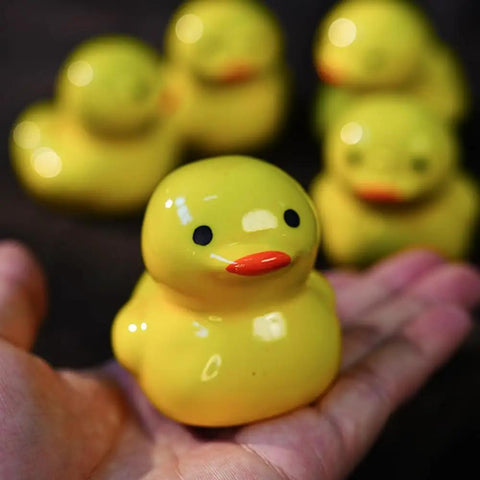 Sweet Ceramic Duck Toilet Bolt Covers For A Fresh Bath Swap Dope Screw Caps With Easy Install And Zero Fuss Upgrades Your Sanitary Hardware Today, showcased in a hand.