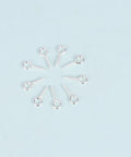 Close-up of plated iron round eye hooks from 600-Piece Sheep Eye Screw Kit with self-tapping screws arranged in a circle.