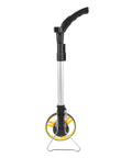 Marhynchus Folding Distance Measuring Wheel with Digital Display in upright position, silver handle, black wheel, yellow accents.
