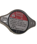 Honda Radiator Cap Compatible With 1994-2006 Accord, 1992-2005 Civic, side view showing warning label and 1.1 pressure rating