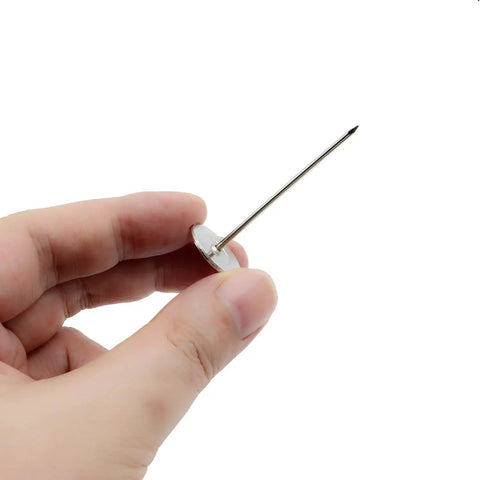 Hand holding a Premium Upholstery Nail with a slick silver flat head, ideal for sofa restorations and DIY projects.