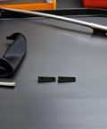 40Pcs Universal Fit Car Door Shock Absorber Pads Rubber Buffer Damper Deadener For Noise Reduction And Super Quiet Latch Guard Cushion To Kill Those Bangs showing two black rubber pads on a gray surface.