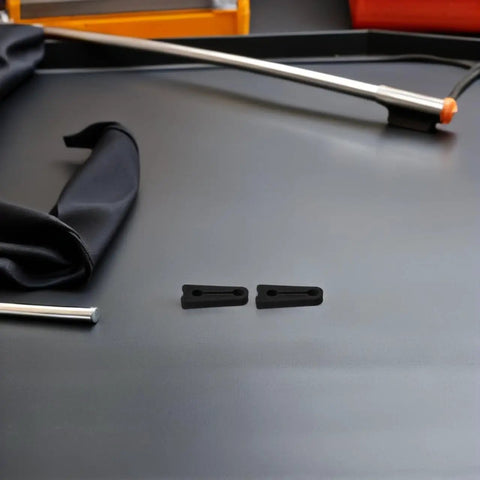 40Pcs Universal Fit Car Door Shock Absorber Pads Rubber Buffer Damper Deadener For Noise Reduction And Super Quiet Latch Guard Cushion To Kill Those Bangs showing two black rubber pads on a gray surface.