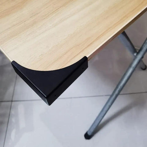 Heavy Duty Black Metal Corner Protectors Four Piece Set Straight Up Solid Edge Guards For Furniture Cabinets And Shipping Crates on a desk corner.