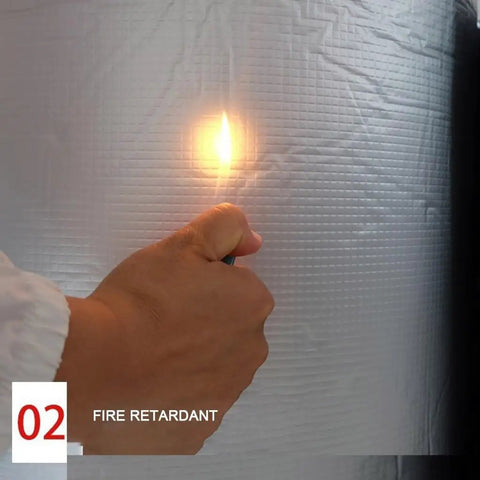 Hand holding a flame near Super Sticky High Density Acoustic Foam Wall Panels With Built In Aluminum Foil.