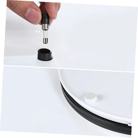 Close-up of connector being inserted into the base of the Sparkling 360 Rotating Turntable Display Stand For Jewelry Watches And Digital Products Mirror Base Electric Spin Platform Perfect For Retail Showcase Home Decor Or Modeling Tools Smooth ABS Construction.