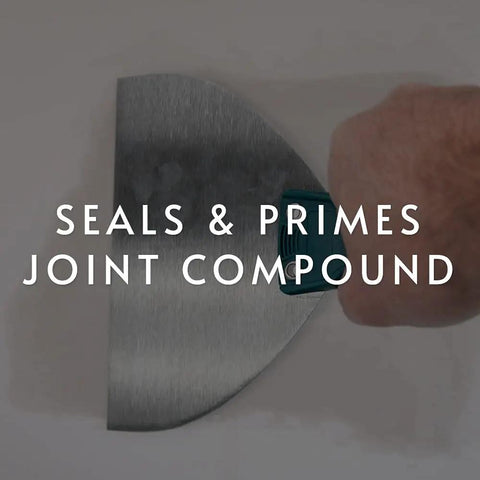 Person applying clear water based primer sealer for drywall and wallpaper, low VOC 5 gallon kit to a wall surface with a putty knife