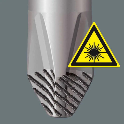 Close-up of metallic pointed tool with spiral grooves and laser warning sign, showcasing industrial precision tip design.