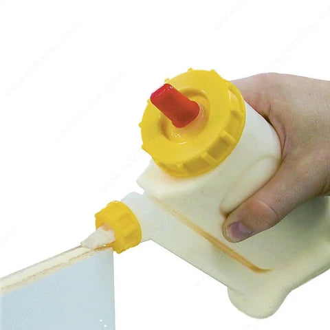 Person using Dripless Wood Glue Dispenser 16 Oz Bottle With Two Chamber Design for precise woodworking application.