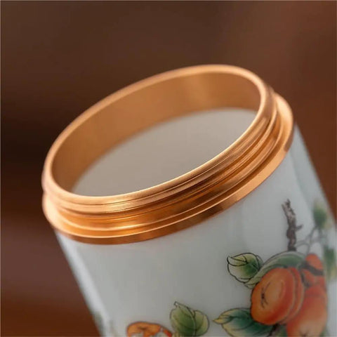 Close-up view of the gold lid of Top Tier Ceramic Food Storage Jars Set Of Twelve With Airtight Snap Lids.