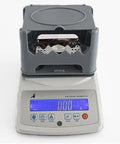 Knockout Precision Digital Density Meter That Slacks On Setup But Delivers Heavy Duty Gravimeter Results For Rubber Solid Granules And Thin Films With Zero Sweat Auto Calibration on a white background.