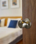 Terrace Keyed Entry Door Knob in Satin Nickel, 6 Way Universal Fit, installed on a wooden bedroom door, includes faceplate and latch.