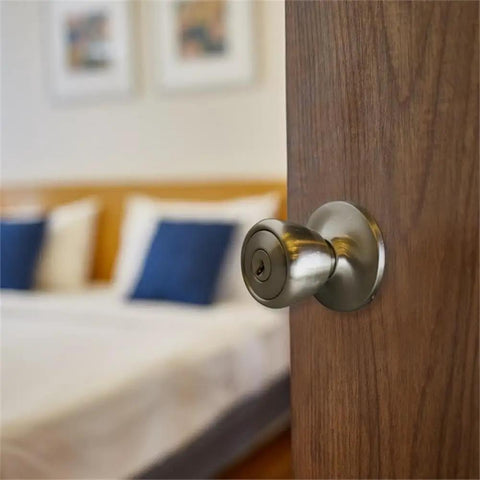 Terrace Keyed Entry Door Knob in Satin Nickel, 6 Way Universal Fit, installed on a wooden bedroom door, includes faceplate and latch.