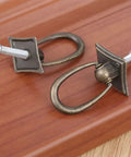 Two Piece Ring Handle Antique Bronze Pull With Screws For Drawers Doors Cabinets Or Vintage Chests Easy To Install Adds That Classic Rustic Retro Vibe To Kitchen Living Room Bedroom And More on wooden surface