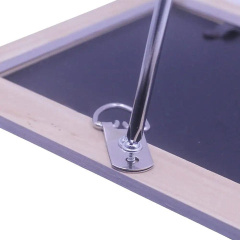 Close-up of Heavy Duty D Ring Picture Hangers With Included Wall Screws, 20 Pack showing installation on a picture frame.