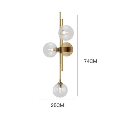 Three Light Modern Wall Sconce With Clear Glass Globe And Gold Base For Bedside Or Living Room Sleek Gold Wall Lamp Delivers Warm Ambient Glow And Contemporary Decor