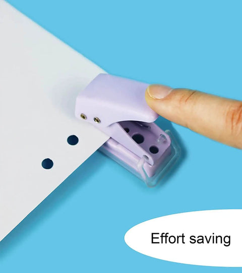 User demonstrating the Two Pack Mini Purple And Pink One Quarter Inch Circle Hole Punch Handheld Paper And Leather Craft Tool punching paper.