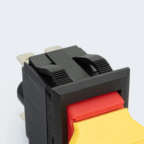Close-up of Dual Voltage Emergency Stop Paddle Switch 16 Amp, featuring a red and yellow paddle, designed for safety on power tools.