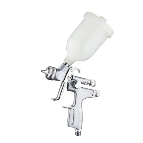 Mini Pneumatic Paint Sprayer Featuring 1.0 Mm Brass Flow Cap And Corrosion Resistant Needle For Straightforward Auto Detailing And Slick Finish Airbrush Jobs Built Tough For Top Shelf Durability, side view showing clear cup.