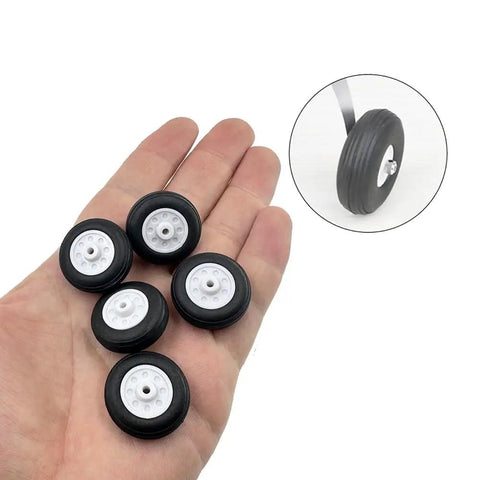 Hand holding Dope 5 Pack Light Sponge RC Wheel Tires With Plastic Hubs For Model Planes And Helicopters, showing 1 inch wheels