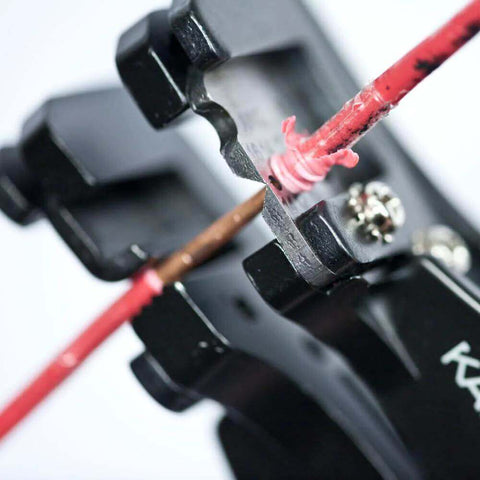 Close-up of Heavy Duty Automatic Wire Cutter and Stripper removing insulation from wire, showing blade action.