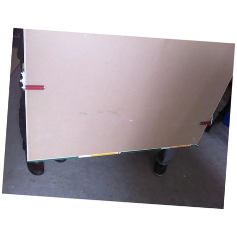 No Sweat Drywall And Gypsum Board Lifter Set Adjustable Angle Handles holding a gypsum board for transport at a jobsite.
