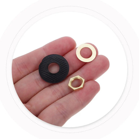 Hand holding components from Quartz Clock Washer Kit For DIY Wall Clocks With 30 Sets Includes Nuts Rubber Washers And Fittings For Easy Clock Repair