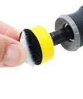 Close-up of 110 Piece 1 Inch Sanding Disc Set With Shank And Backing Pads 40 To 600 Grit Hook And Loop Abrasive Kit being held near drill.