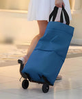 Collapsible Shopping Cart With 360 Degree Swivel Wheels in use, blue foldable tote cart being pulled on a tiled floor, ideal for errands.